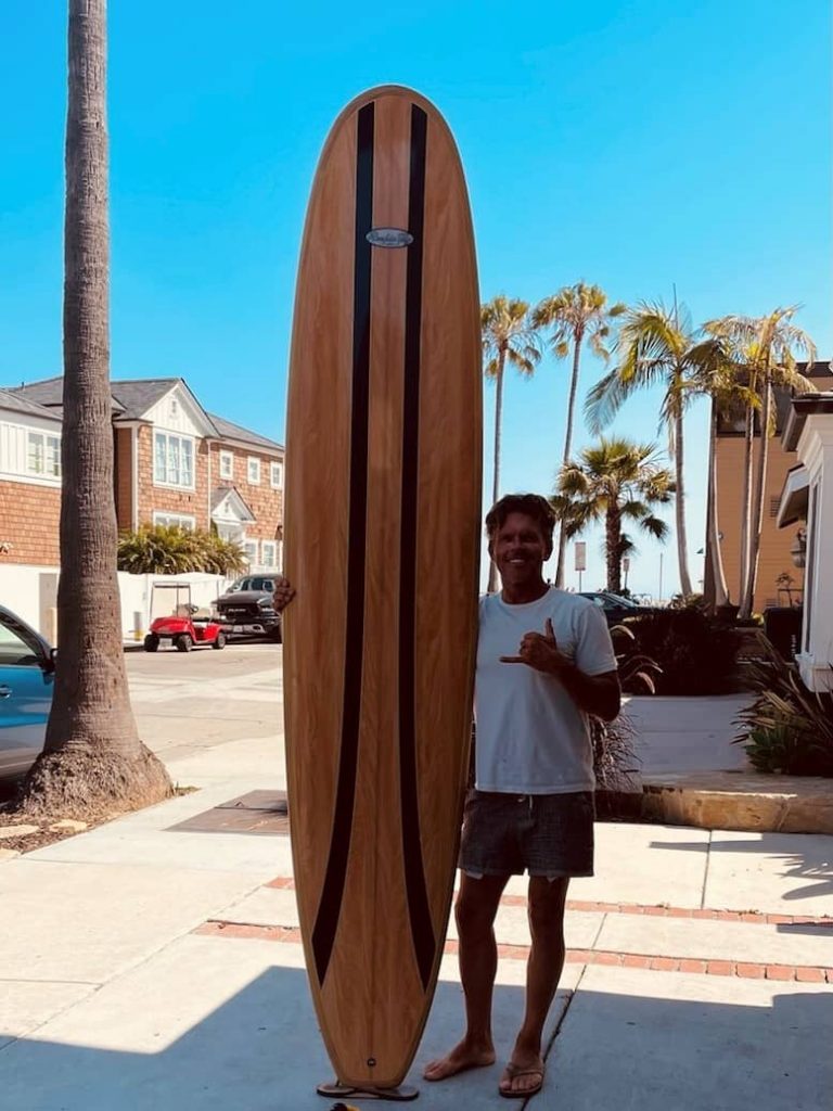 Casey with his surfboard